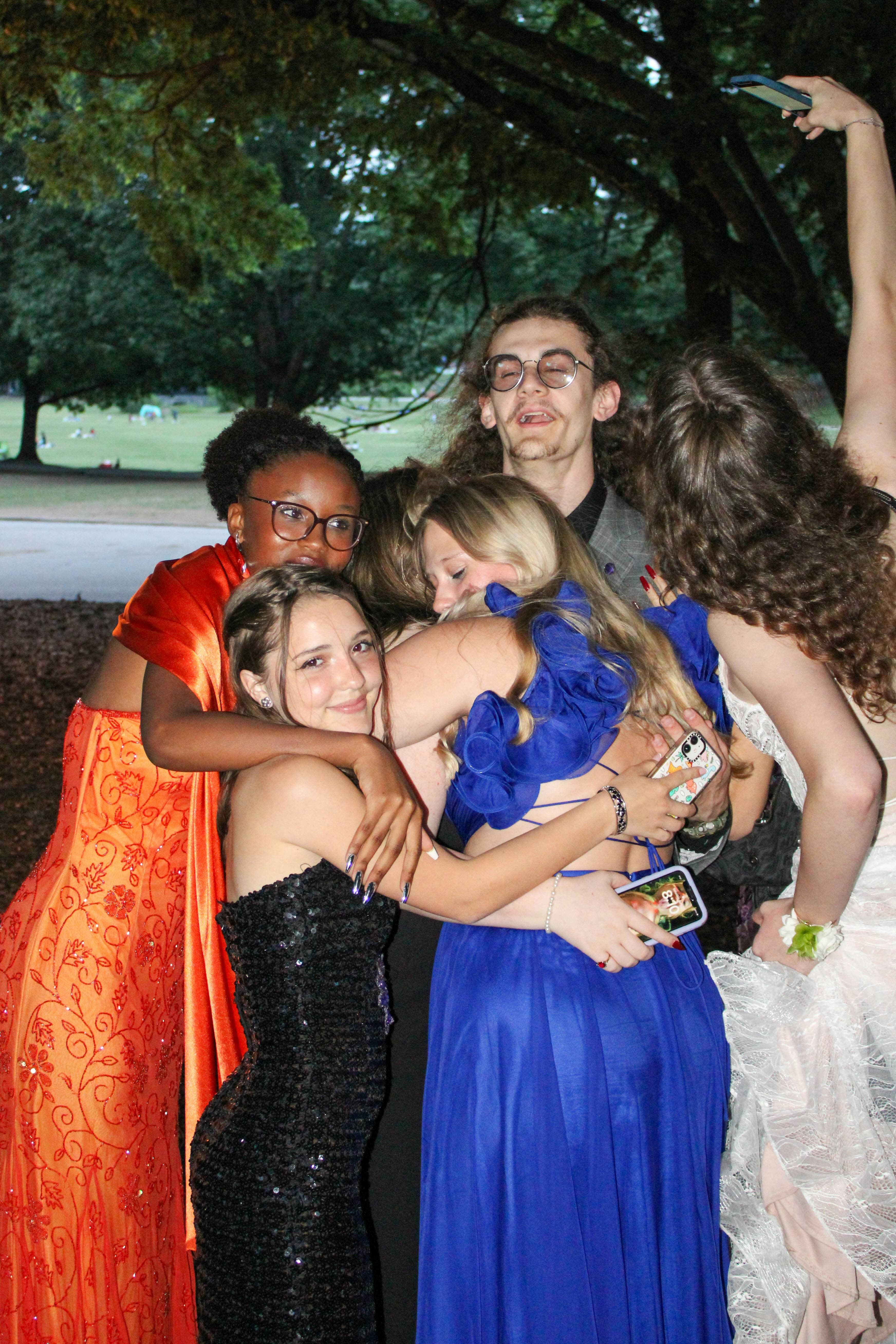 High school friends dressed up and laughing together before a school dance