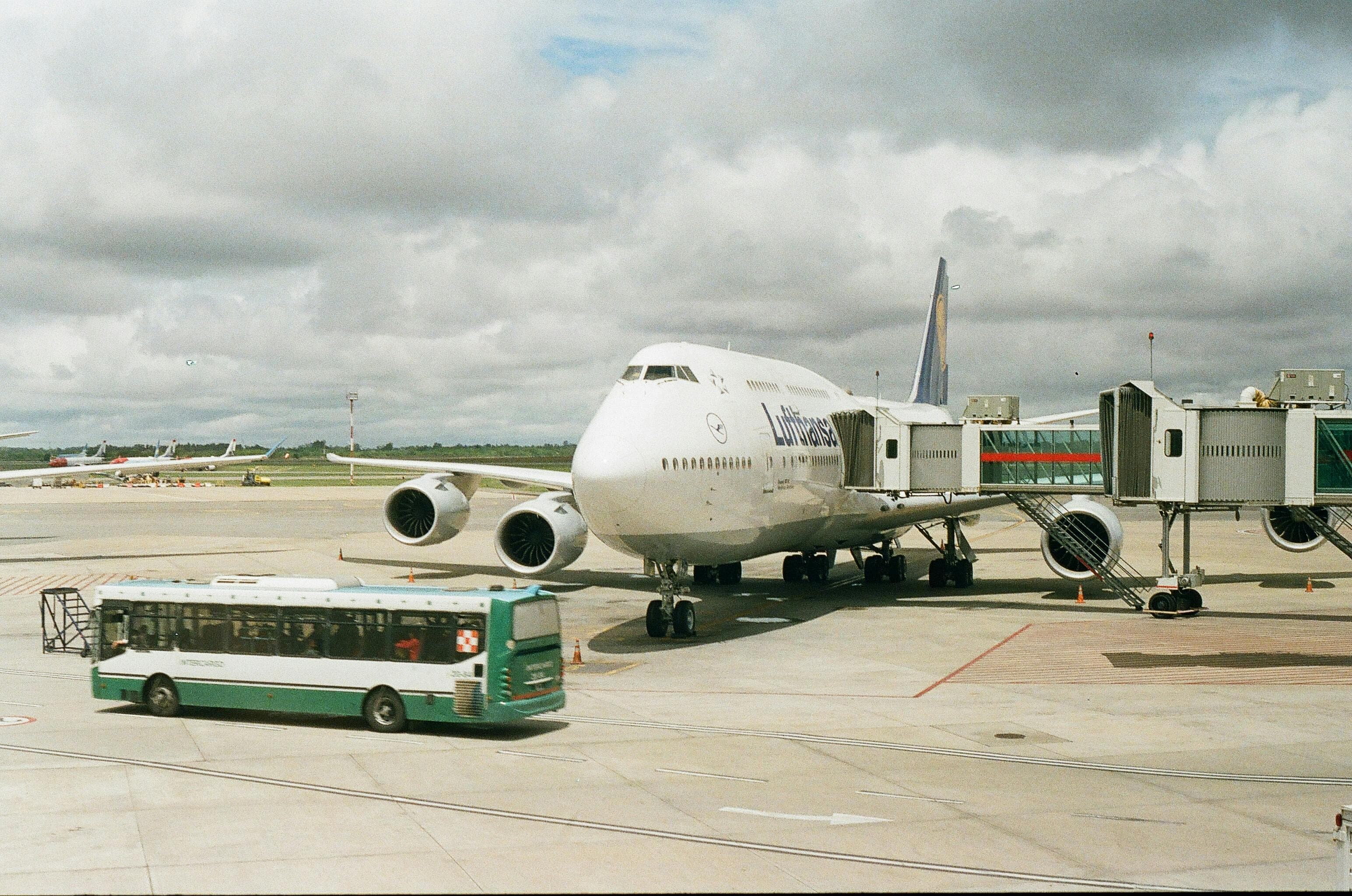 Travelers loading suitcases into a chartered airport shuttle bus