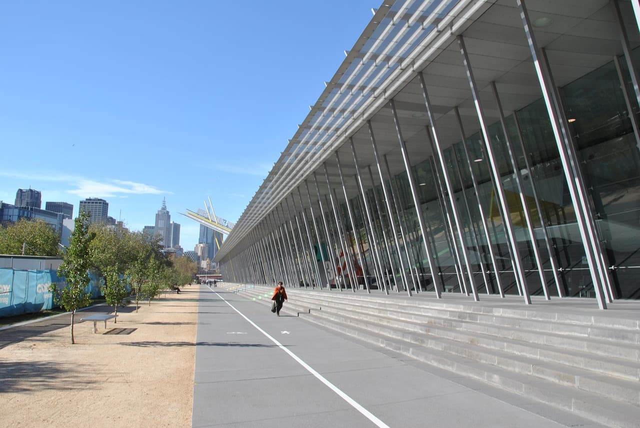 Convention attendees gathering outside a venue before boarding a group shuttle