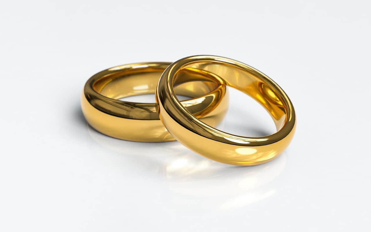 Couple celebrating a vow renewal with guests gathered around them